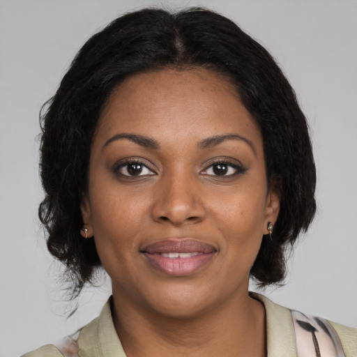 Joyful black young-adult female with medium  black hair and brown eyes