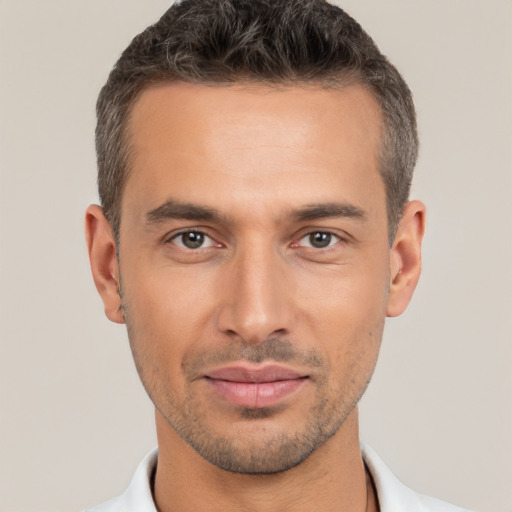 Joyful white young-adult male with short  brown hair and brown eyes