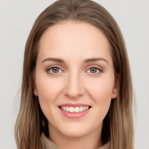 Joyful white young-adult female with long  brown hair and grey eyes