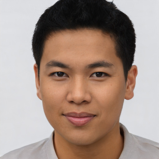 Joyful asian young-adult male with short  black hair and brown eyes