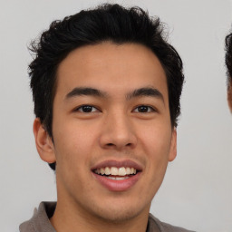 Joyful latino young-adult male with short  brown hair and brown eyes