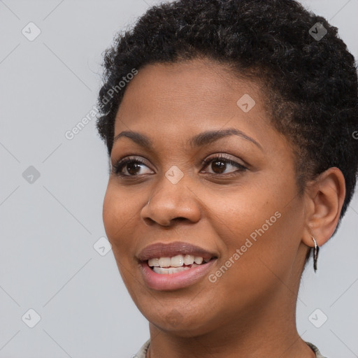 Joyful black young-adult female with short  brown hair and brown eyes