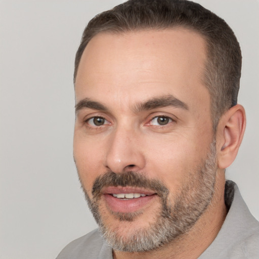 Joyful white adult male with short  brown hair and brown eyes