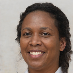 Joyful black adult female with medium  brown hair and brown eyes