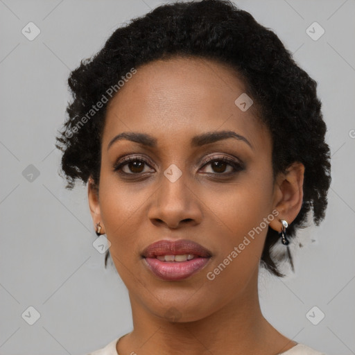 Joyful black young-adult female with short  black hair and brown eyes