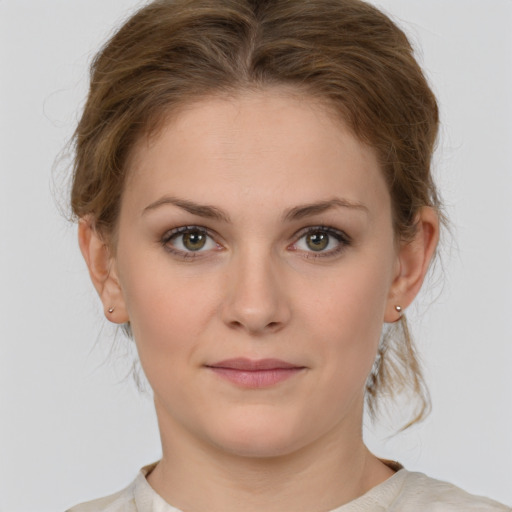 Joyful white young-adult female with medium  brown hair and grey eyes