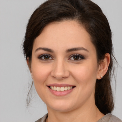 Joyful white young-adult female with medium  brown hair and brown eyes