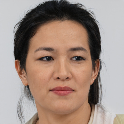 Joyful asian adult female with medium  brown hair and brown eyes