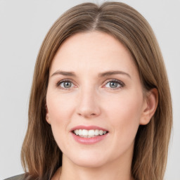 Joyful white young-adult female with medium  brown hair and green eyes