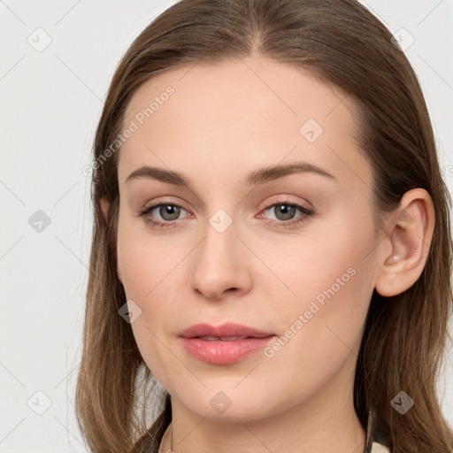 Joyful white young-adult female with long  brown hair and grey eyes