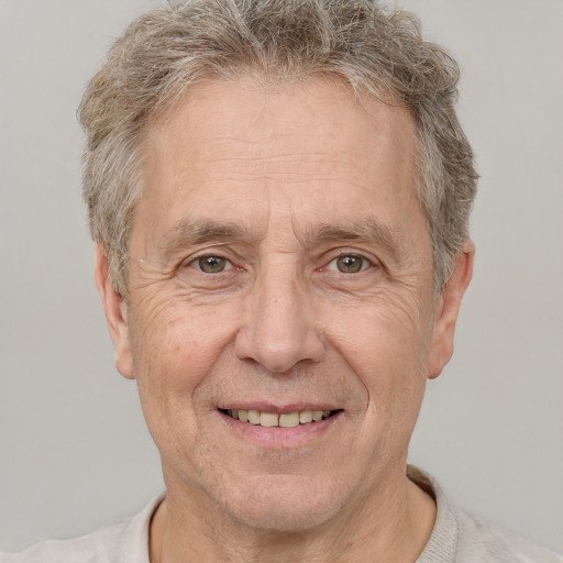 Joyful white middle-aged male with short  gray hair and brown eyes