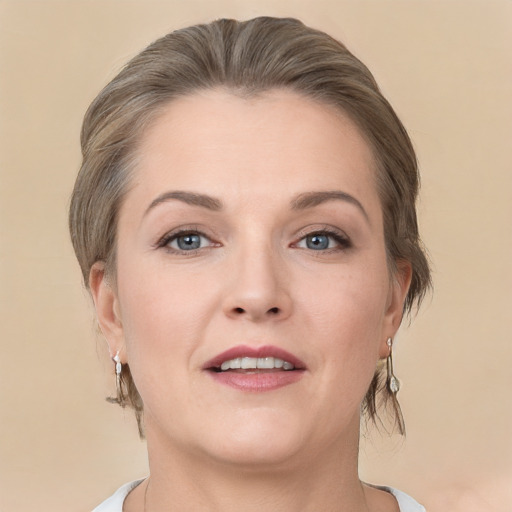 Joyful white young-adult female with medium  brown hair and grey eyes