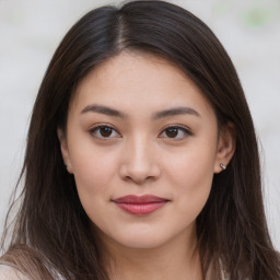 Joyful asian young-adult female with long  brown hair and brown eyes