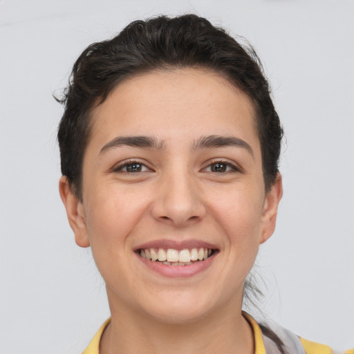 Joyful white young-adult female with short  brown hair and brown eyes