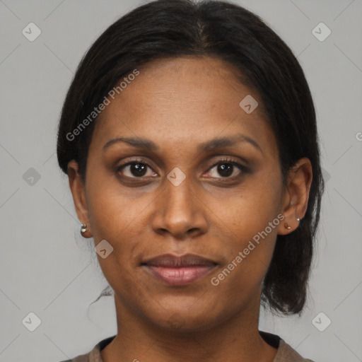 Joyful black adult female with medium  brown hair and brown eyes