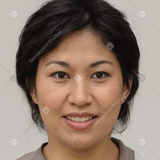 Joyful asian adult female with medium  brown hair and brown eyes