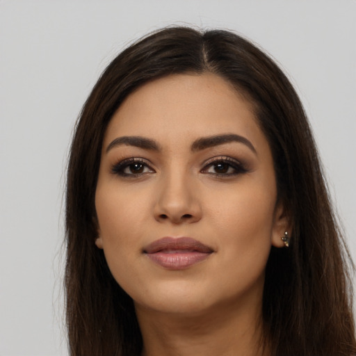 Joyful latino young-adult female with long  brown hair and brown eyes