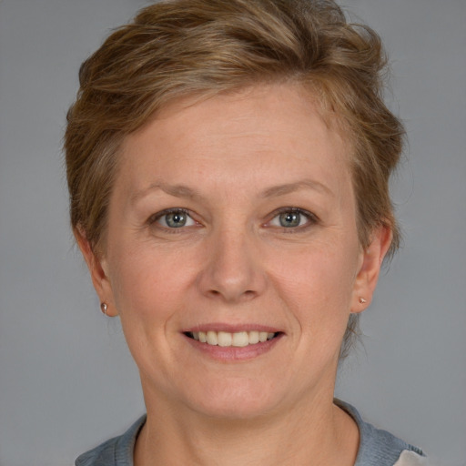 Joyful white adult female with short  brown hair and grey eyes