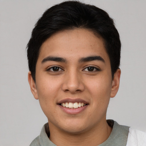 Joyful latino young-adult female with short  black hair and brown eyes