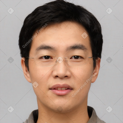 Joyful asian young-adult male with short  black hair and brown eyes