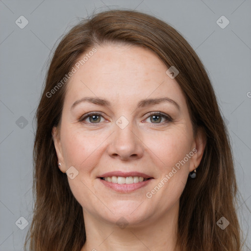 Joyful white adult female with long  brown hair and grey eyes