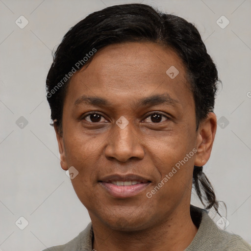 Joyful latino adult male with short  black hair and brown eyes