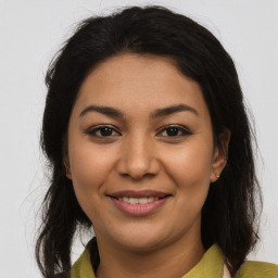 Joyful latino young-adult female with medium  brown hair and brown eyes