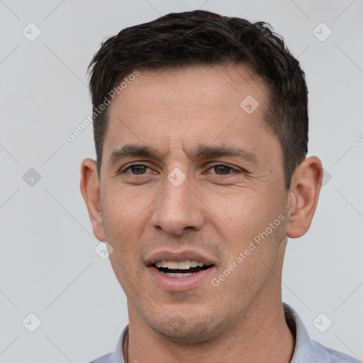 Joyful white young-adult male with short  black hair and brown eyes