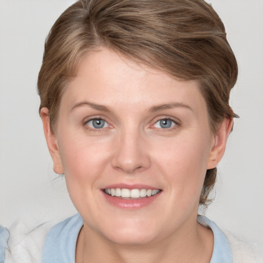 Joyful white young-adult female with medium  brown hair and blue eyes