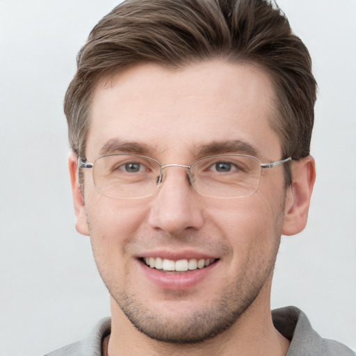 Joyful white adult male with short  brown hair and grey eyes