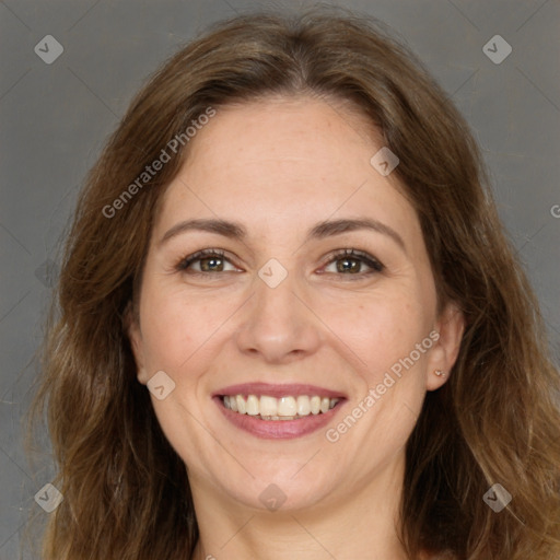 Joyful white adult female with long  brown hair and brown eyes