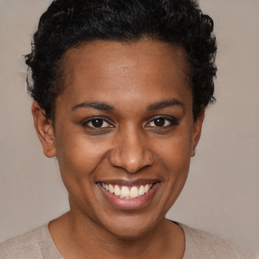 Joyful black young-adult female with short  brown hair and brown eyes