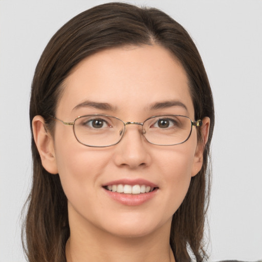 Joyful white young-adult female with medium  brown hair and grey eyes