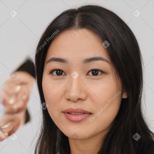 Joyful asian young-adult female with long  brown hair and brown eyes