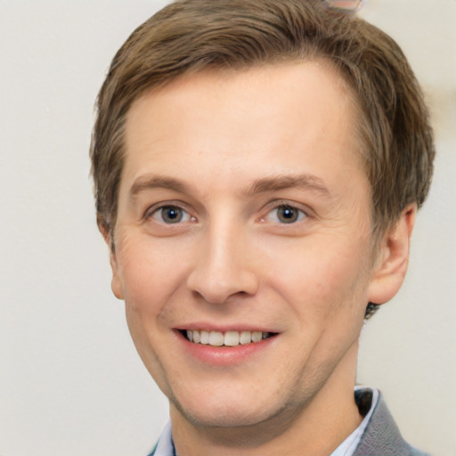 Joyful white adult male with short  brown hair and grey eyes