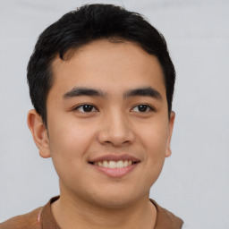 Joyful asian young-adult male with short  brown hair and brown eyes