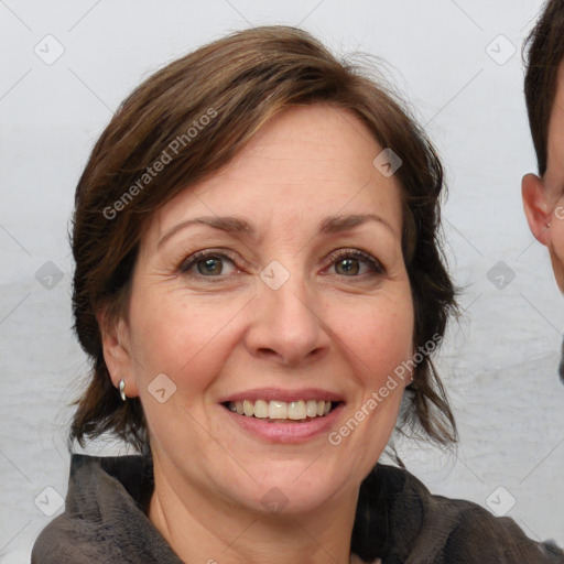 Joyful white adult female with medium  brown hair and grey eyes