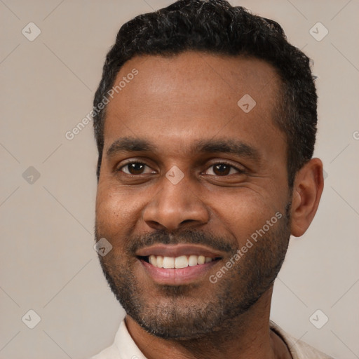 Joyful latino young-adult male with short  black hair and brown eyes