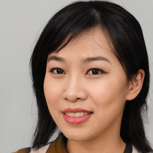 Joyful asian young-adult female with medium  brown hair and brown eyes
