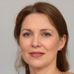 Joyful white adult female with medium  brown hair and grey eyes