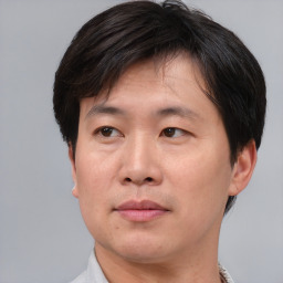 Neutral asian adult male with short  brown hair and brown eyes