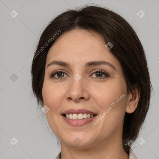 Joyful white adult female with medium  brown hair and brown eyes