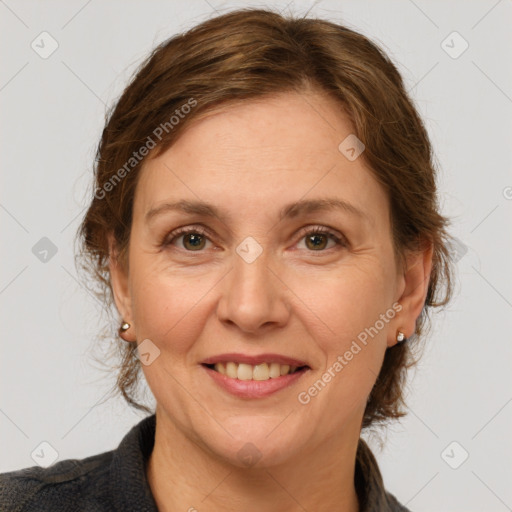 Joyful white adult female with medium  brown hair and grey eyes