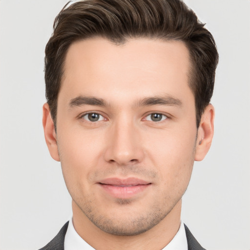 Joyful white young-adult male with short  brown hair and brown eyes