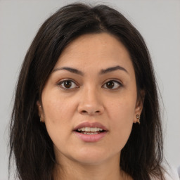 Joyful white young-adult female with long  brown hair and brown eyes