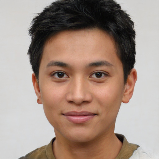 Joyful asian young-adult male with short  brown hair and brown eyes