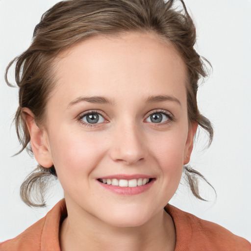 Joyful white young-adult female with medium  brown hair and blue eyes