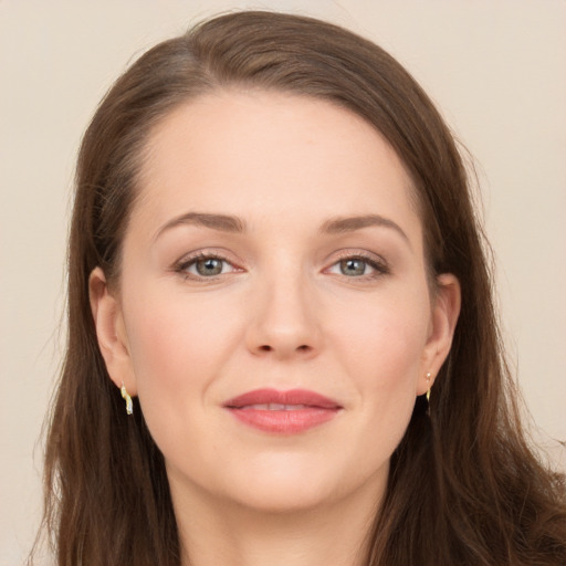 Joyful white young-adult female with long  brown hair and grey eyes