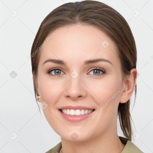 Joyful white young-adult female with long  brown hair and green eyes