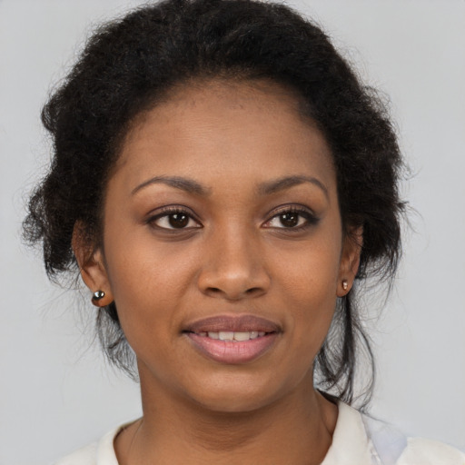Joyful black young-adult female with short  brown hair and brown eyes